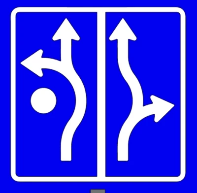 Zastosowanie takich znaków znacząco ułatwiłoby kierowcom zorientowanie się jak poruszać się po danym rondzie Znak drogowy z dwiema opcjami skrętu. Biała strzałka z lewej strony wskazuje możliwość skrętu w lewo przed przeszkodą, natomiast z prawej strony strzałka wskazuje skręt w prawo za przeszkodą.
