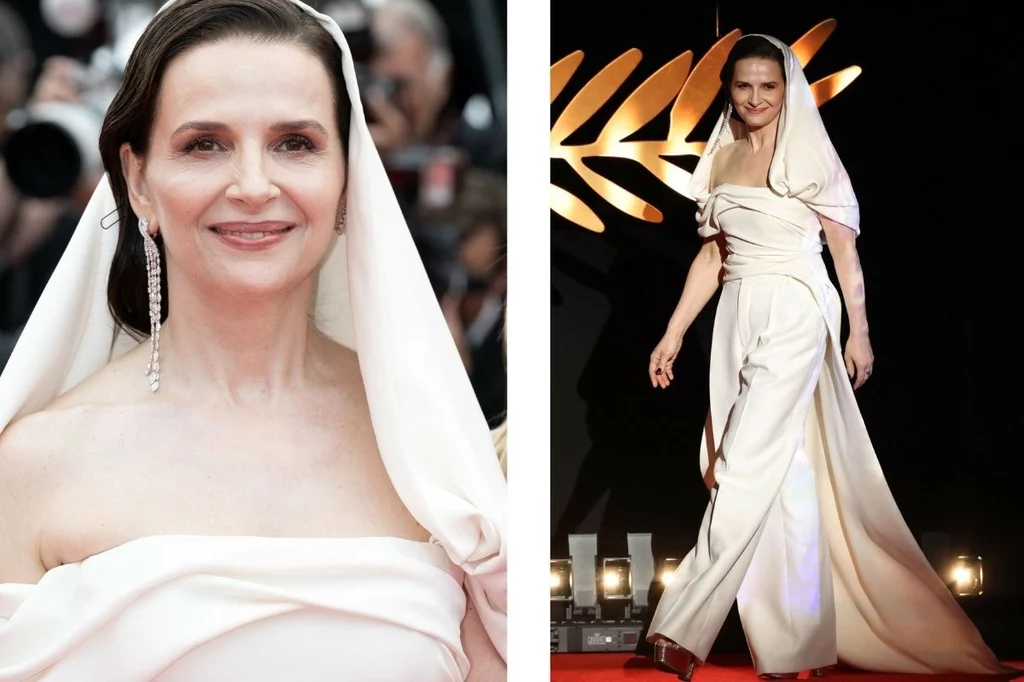 Juliette Binoche na 78. Międzynarodowym Festiwalu Filmowym w Cannes Juliette Binoche ubrana w białą, elegancką bluzkę z kapturem i szerokie spodnie imitujące spódnicę. Nosi długie kolczyki. Idzie po czerwonym dywanie. Wygląda na pewną siebie i uśmiechniętą.
