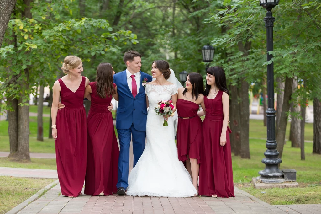 couple walking with the bridesmaids in the same burgundy dresses in Russia couple walking with the bridesmaids in the same burgundy dresses in Russia