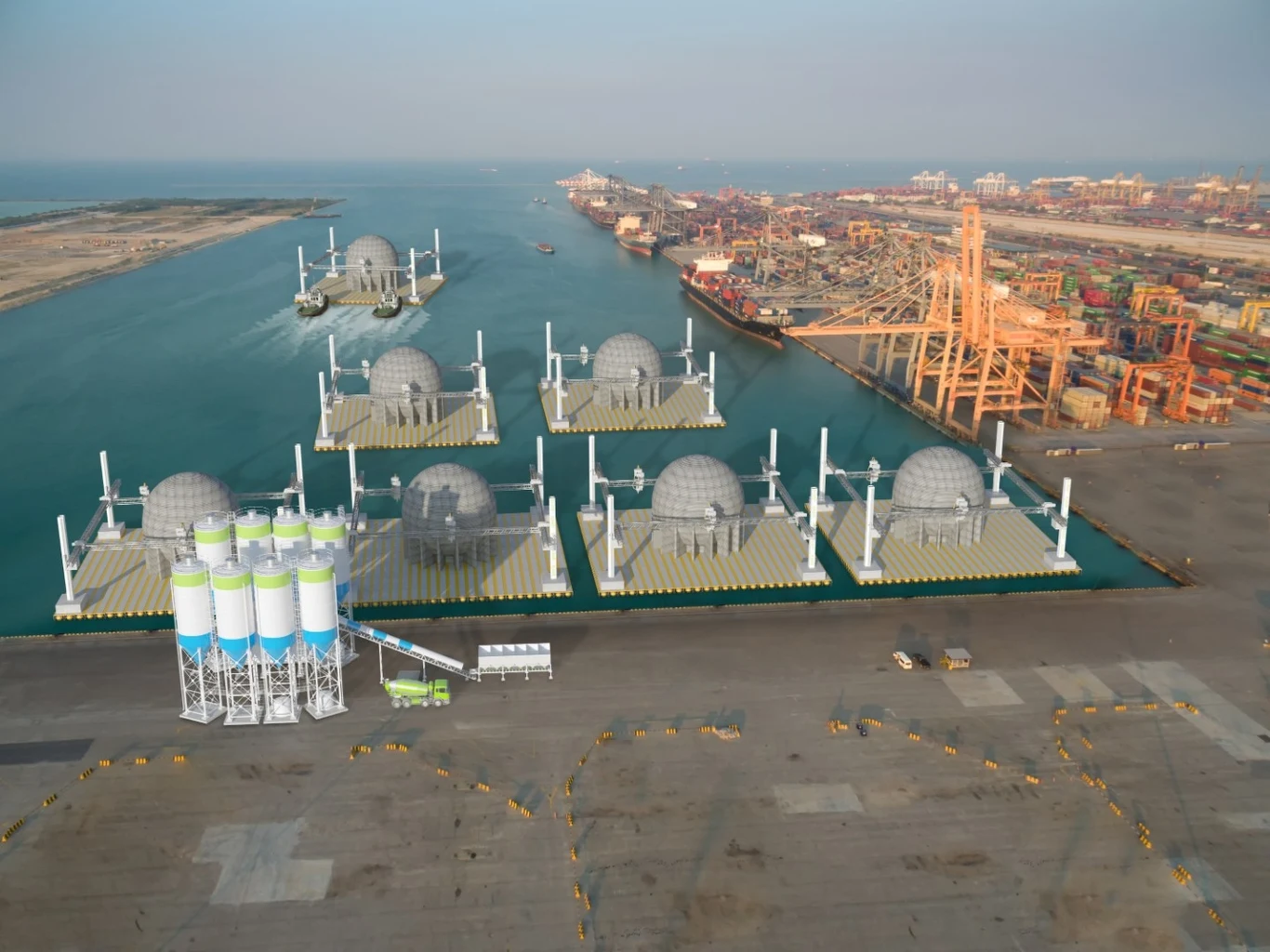 Produkcja 30-metrowych kul dla parku StEnSea. Widok z lotu ptaka na port morski z zaawansowanymi konstrukcjami pływającymi wyposażonymi w kopuły. Wzdłuż nabrzeża widać ogromne dźwigi oraz magazyny, co sugeruje dużą operacyjność i przemysłowy charakter miejsca.