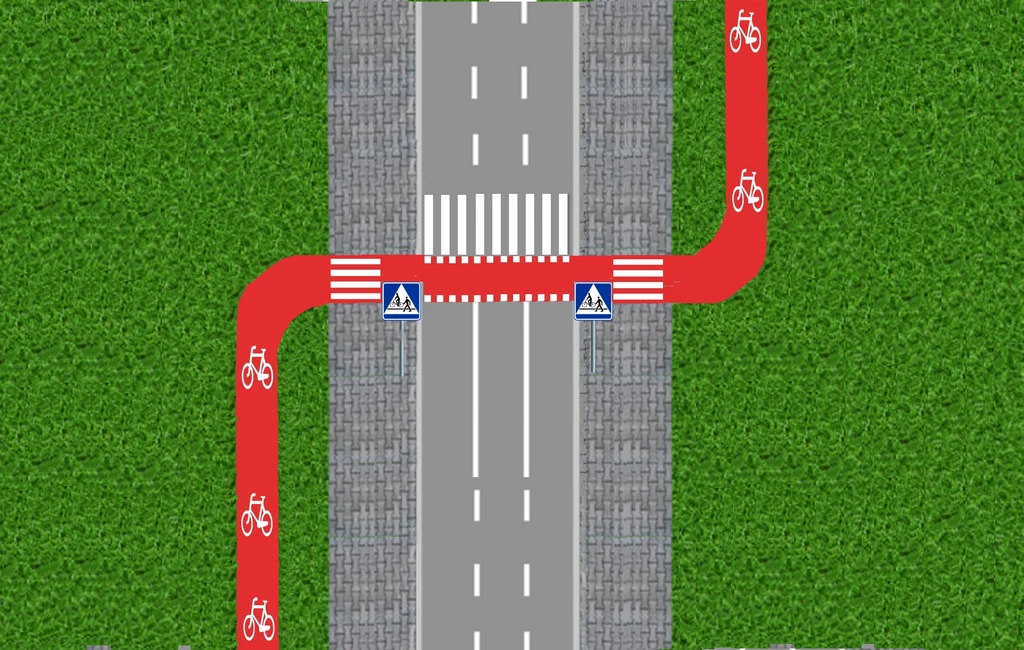 Takie poprowadzenie drogi dla rowerów poprawia bezpieczeństwo Infrastruktura drogowo-rowerowa ukazująca przejście dla pieszych i przejazd dla rowerzystów w otoczeniu zieleni, z wyraźnie oznaczonymi pasami i ścieżką rowerową.