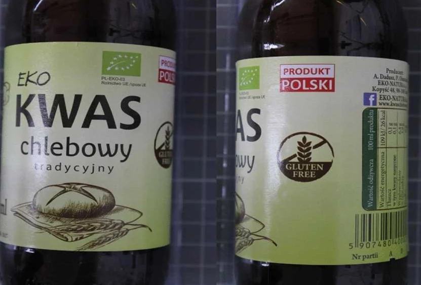 W określonej partii bezglutenowego kwasu chlebowego wykryto gluten Dwie butelki z etykietami 'Eko kwas chlebowy tradycyjny'. Na etykiecie widnieje rysunek chleba oraz oznaczenia typu 'Produkt polski' i 'Gluten free'.