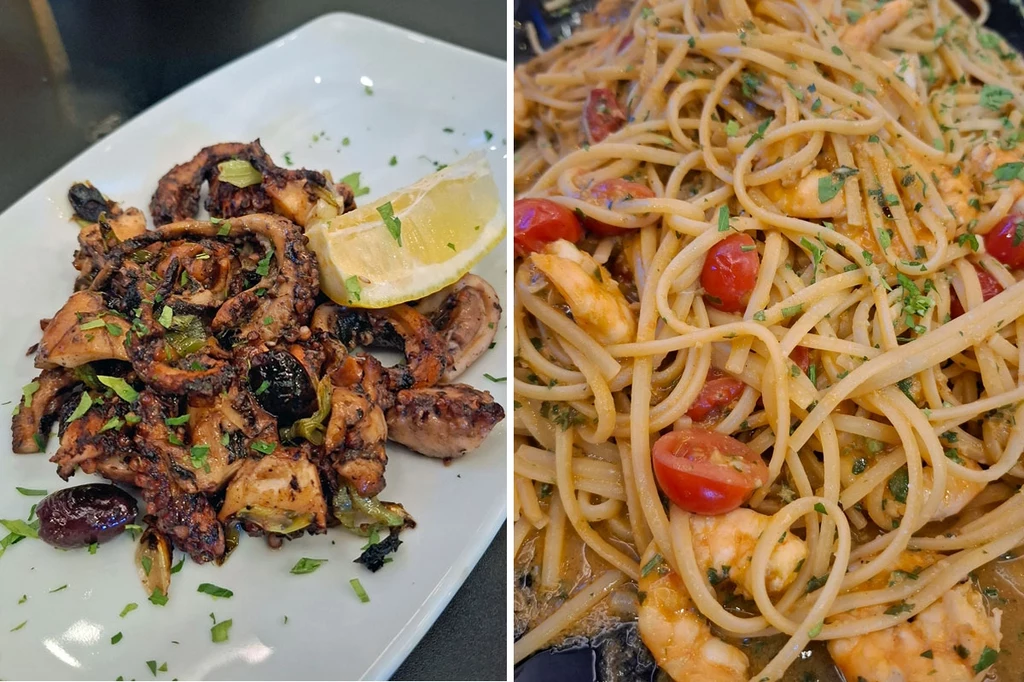 Owoce morza w Pavlino's Grillowana ośmiornica podana z cząstką cytryny na białym talerzu obok makaronu spaghetti z krewetkami, pomidorkami koktajlowymi i posiekanymi ziołami.