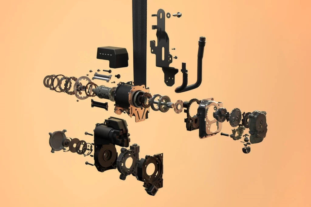 Budowa wieloadaptacyjnego pasa bezpieczeństwa Volvo. Rozłożone na części podzespoły mechaniczne lub elektroniczne unoszące się w przestrzeni na jasnym tle, ukazujące złożoność i szczegóły konstrukcji urządzenia.