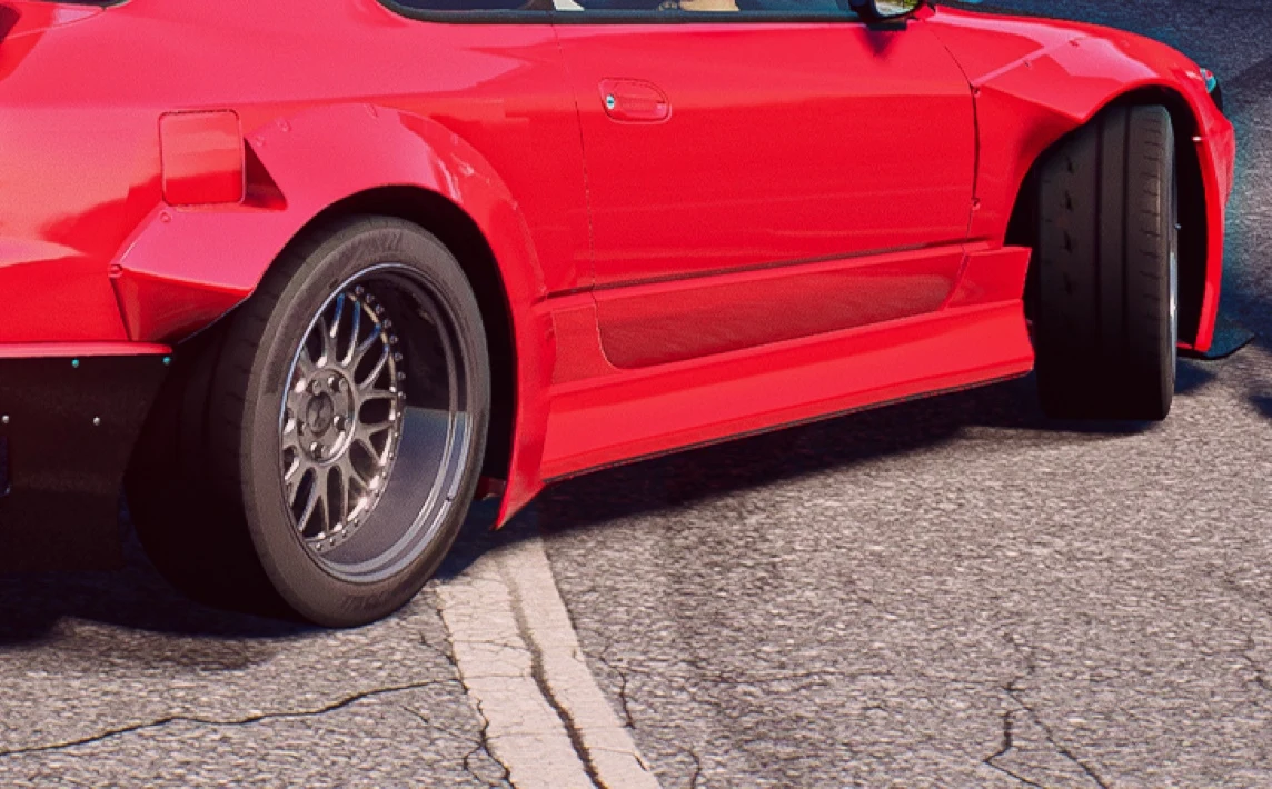 Japanese Drift Master Czerwony samochód sportowy o szerokich nadkolach, niskoprofilowych oponach i felgach aluminiowych, ustawiony na asfalcie z widocznymi białymi liniami oznaczeń drogowych.