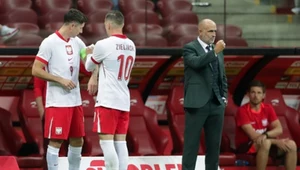 Piotr Zieliński zakłada opaskę kapitana Robertowi Lewandowskiemu. Z boku trener Michał Probierz