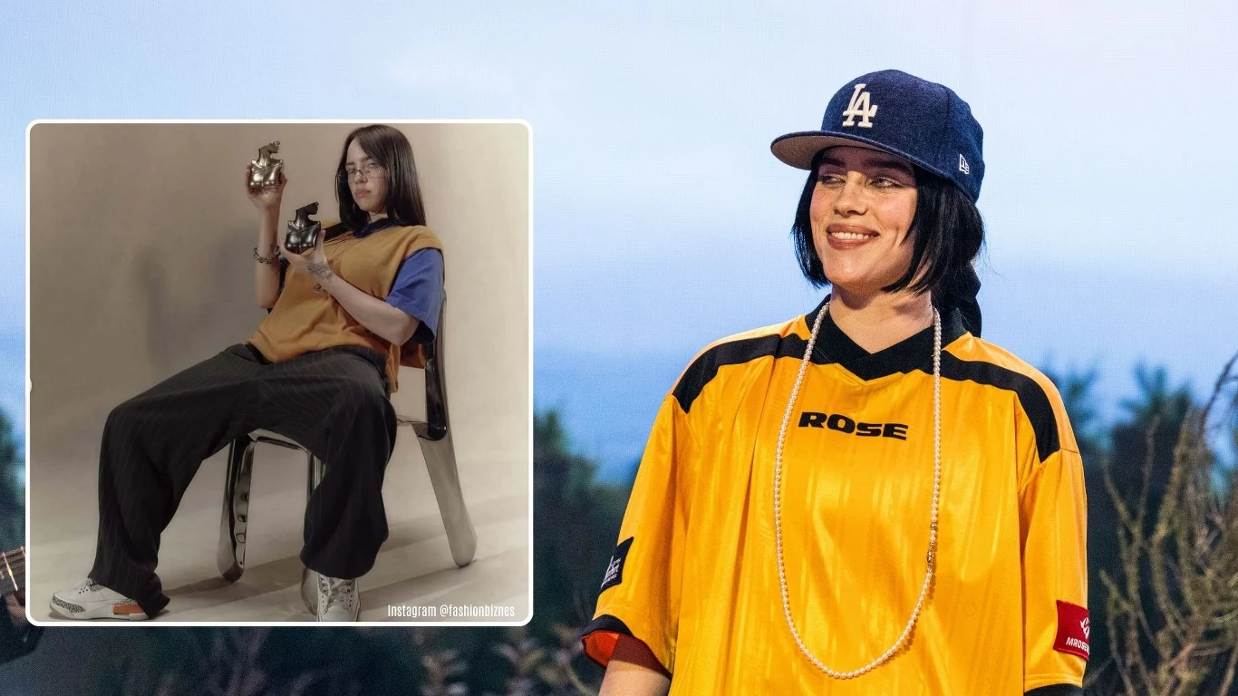 Billie Eilish w najnowszej kampanii perfum "Your Turn" Uśmiechnięta kobieta w żółtej sportowej koszulce z napisem ROSE, naszyjniku z koralików i niebieską czapką z daszkiem z logo LA, stoi na tle rozmazanego pejzażu. W lewym rogu umieszczona jest wstawka z młodą dziewczyną w luźnych ubraniach siedzącą na k...