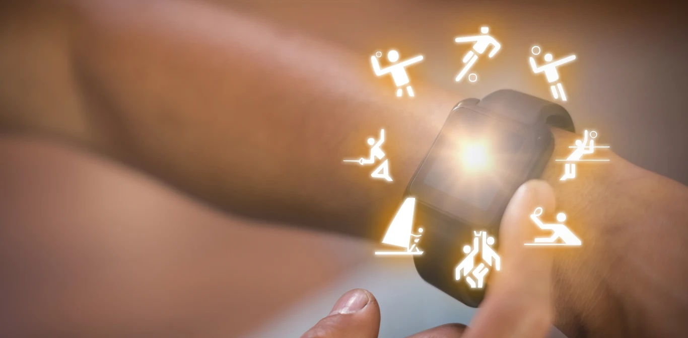 Dbanie o ciało i dom wymaga systematyczności oraz sprytnych narzędzi Męska ręka z założonym smartwatchem, wokół którego wyświetlają się ikony różnych dyscyplin sportowych, takich jak bieganie, jazda na rowerze, pływanie czy siatkówka.