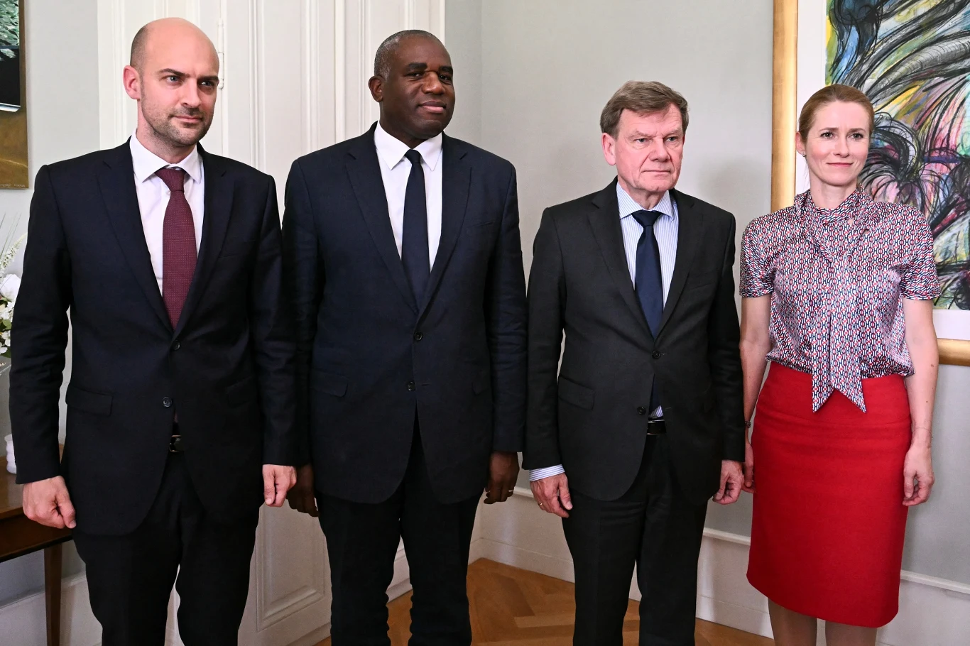 W Genewie doszło do spotkania ws. konfliktu Iran-Izrael Czworo ludzi w formalnych ubraniach pozuje wspólnie w jasnym pomieszczeniu, na ścianie wisi kolorowy obraz.