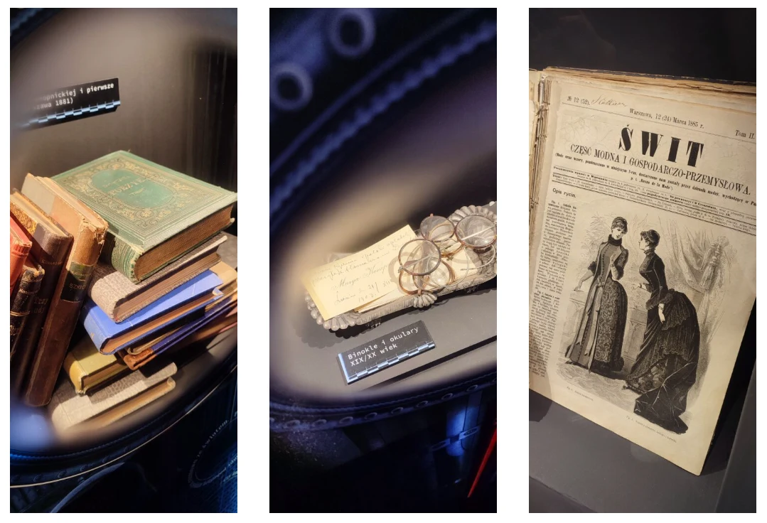 Zbiór starych książek, gazeta z XIX wieku oraz okulary z kopertą eksponowane za szkłem, prezentujące dorobek literacki i prasowy z przeszłości.