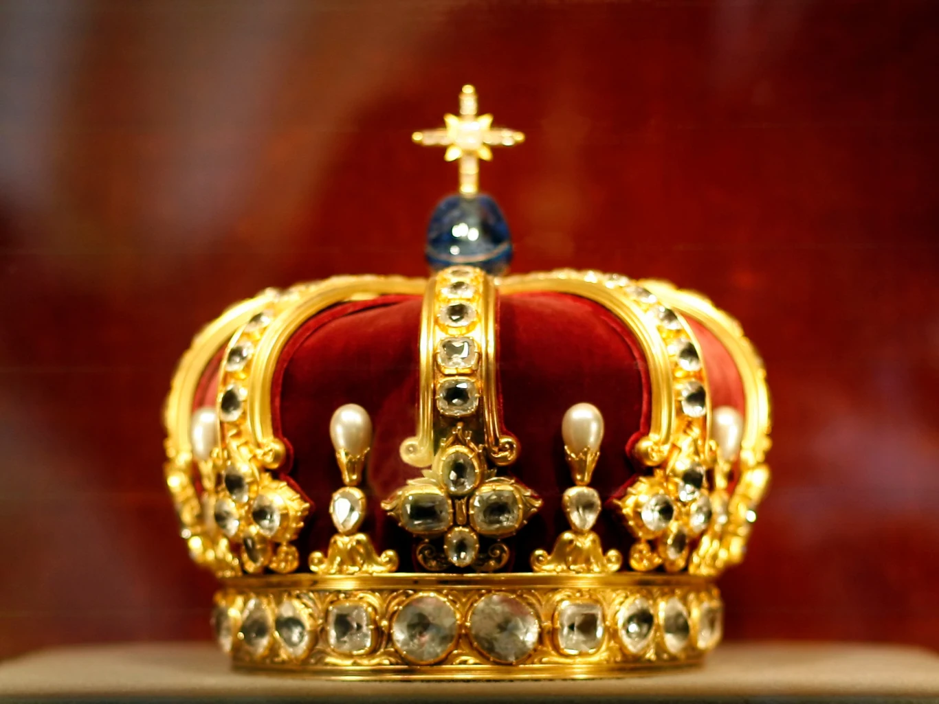Korona Wilhelma II, ostatniego króla Prus i cesarza Niemiec. To jeden z tysięcy skarbów Hohenzollernów. Co się z nimi stanie? Złota korona wysadzana perłami i kamieniami szlachetnymi, z czerwonym welurem wewnątrz, zwieńczona niebieskim kamieniem i krzyżem na górze, eksponowana na czerwonym tle.