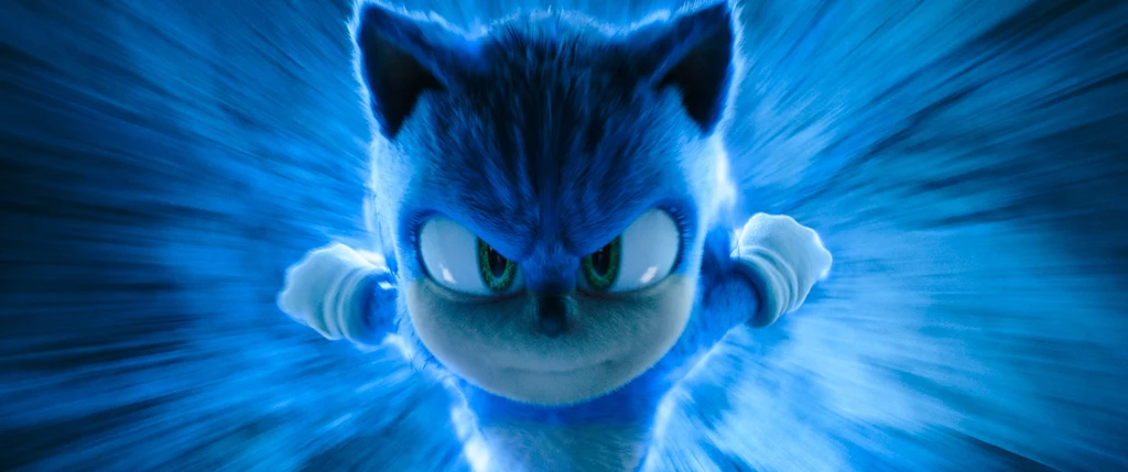 Sonic 3: Szybki jak błyskawica Niebieski animowany jeż w energicznej pozie biegnie z ogromną prędkością, otoczony świetlistym, rozmazanym tłem w odcieniach błękitu i bieli.