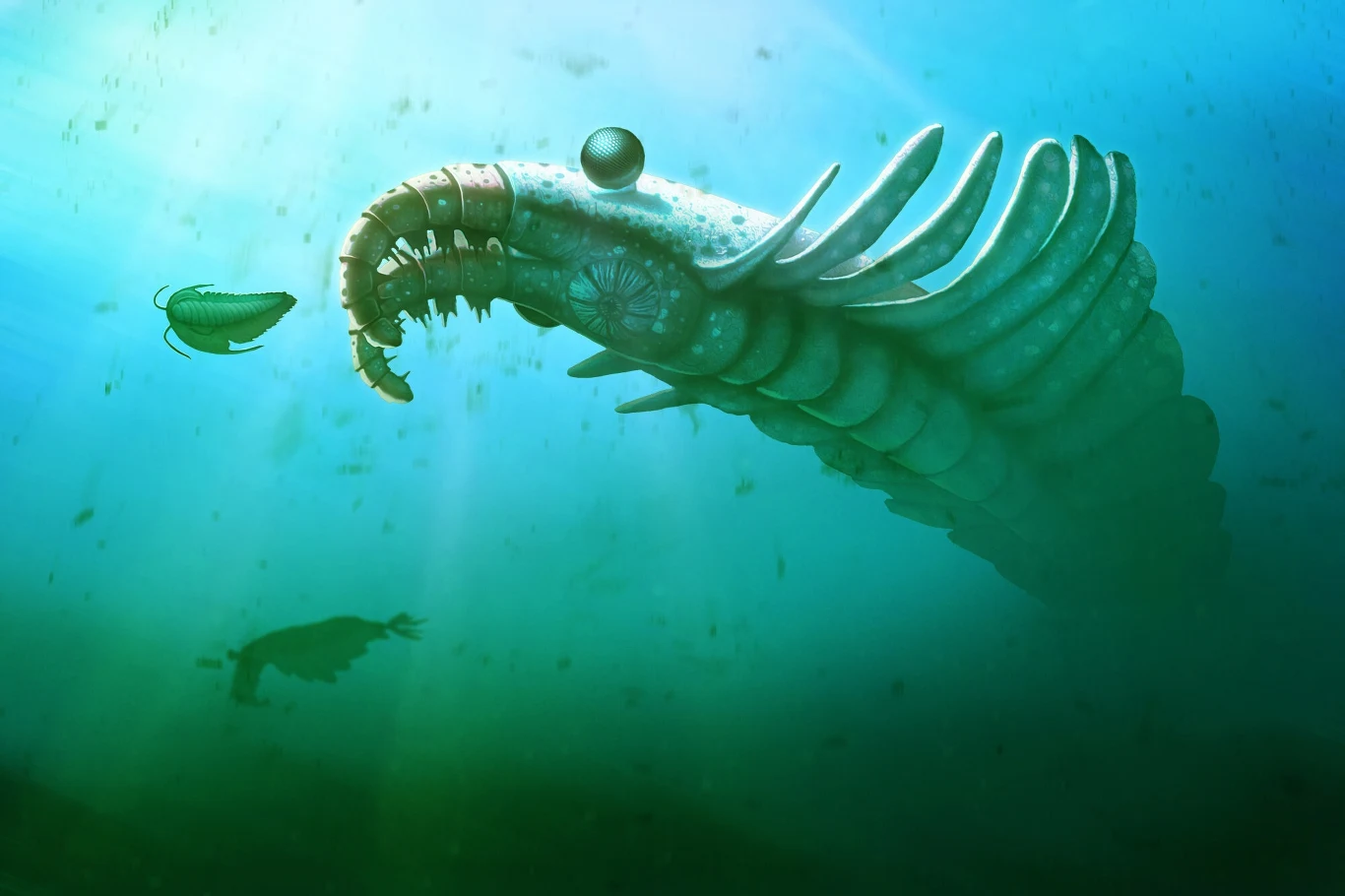 Ogromny prehistoryczny morski drapieżnik z segmentowanym ciałem i dużą szczęką zbliża się do mniejszego wodnego stworzenia, głębia wody rozświetlona promieniami słonecznymi.