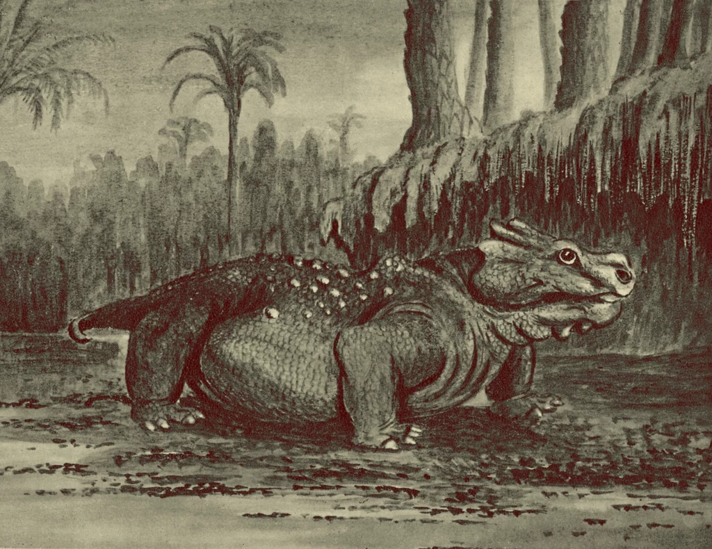 Duży, prehistoryczny gad poruszający się po wilgotnym terenie otoczonym wysokimi paprociami drzewiastymi i palmami, w tle widoczne gęste zarośla i wysokie, masywne drzewa, całość utrzymana w stylu dawnych rycin paleontologicznych.