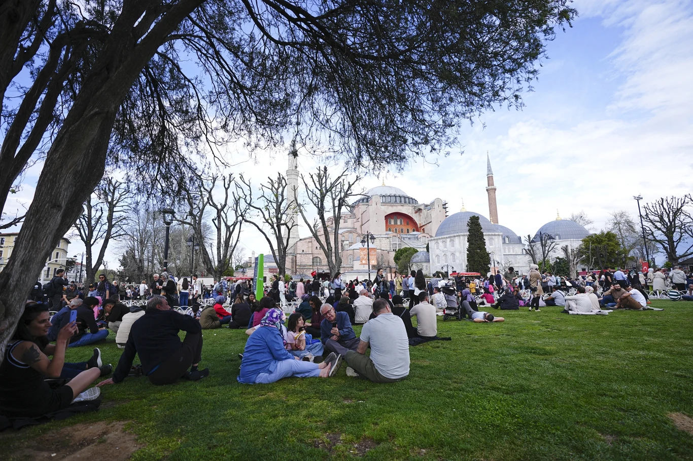 Tureckie władze aresztują polityków opozycji. Zatrzymany został m.in. burmistrz Stambułu Tłum ludzi wypoczywający na zielonym trawniku w otoczeniu drzew na tle historycznego meczetu i budynków, przy słonecznej pogodzie.
