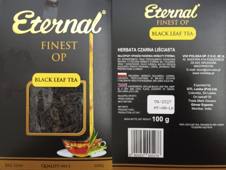 Czarne opakowanie herbaty liściastej Eternal Finest OP z widocznym okienkiem prezentującym suche liście herbaty, żółte etykiety z nazwą produktu, informacje o składzie, sposobie parzenia oraz miejscu pochodzenia i dacie ważności; grafika filiżanki z he...