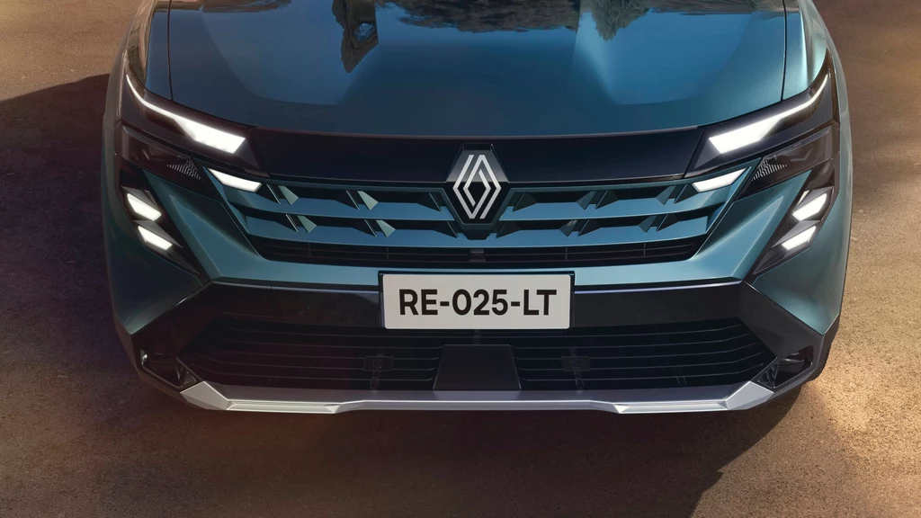 Przód Renault Boreal wyróżnia się charakterystyczną kratką w kolorze nadwozia oraz oświetleniem LED. Frontowa część nowoczesnego samochodu marki Renault z wyraźnie widocznym logo oraz charakterystycznym grillem i reflektorami LED, tablica rejestracyjna RE-025-LT na tle asfaltu.