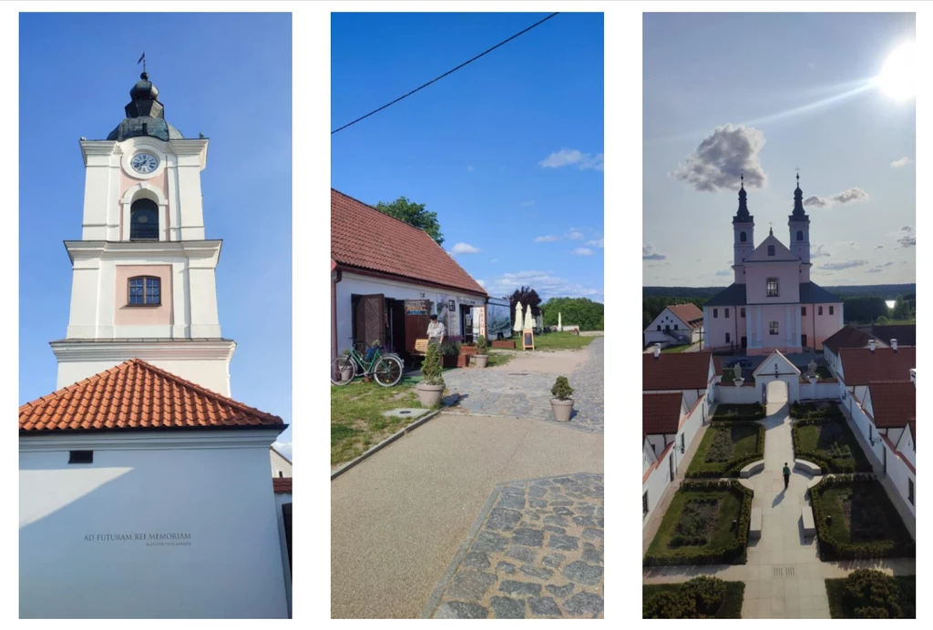 Pokamedulski Klasztor w Wigrach Widok wieży zegarowej kościoła z dachem pokrytym czerwoną dachówką, tradycyjne zabudowania wiejskie z rowerem opartym o ścianę oraz kompleks klasztorny z dwoma wysokimi wieżami, otoczony zadbanym dziedzińcem i alejkami.