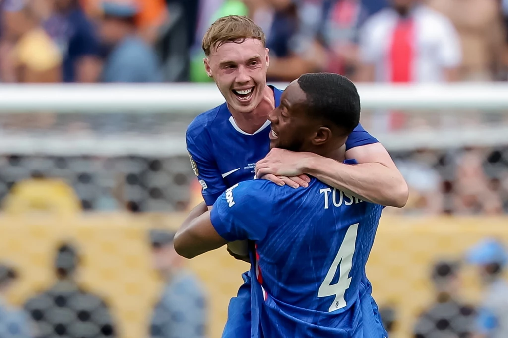 Cole Palmer strzelił dwa gole w finale KMŚ Dwóch piłkarzy w niebieskich koszulkach świętuje radośnie po zdobyciu gola, obejmując się na tle stadionu i rozmytej publiczności.