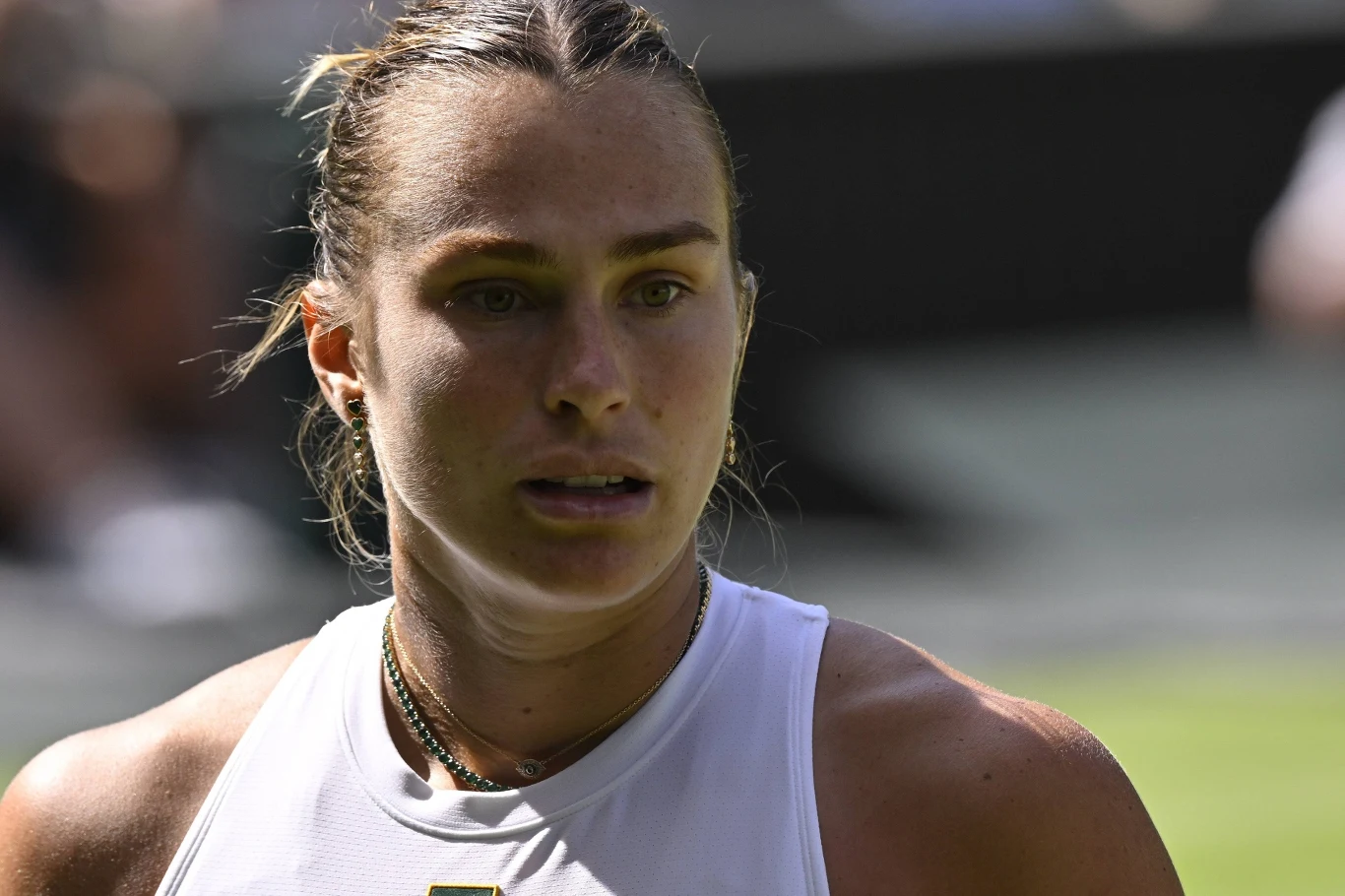 Aryna Sabalenka przegrała z Amandą Anisimovą w półfinale Wimbledonu Kobieta w sportowym stroju na tle kortu tenisowego, widoczna twarz i skupienie, światło podkreśla emocje i wysiłek fizyczny.