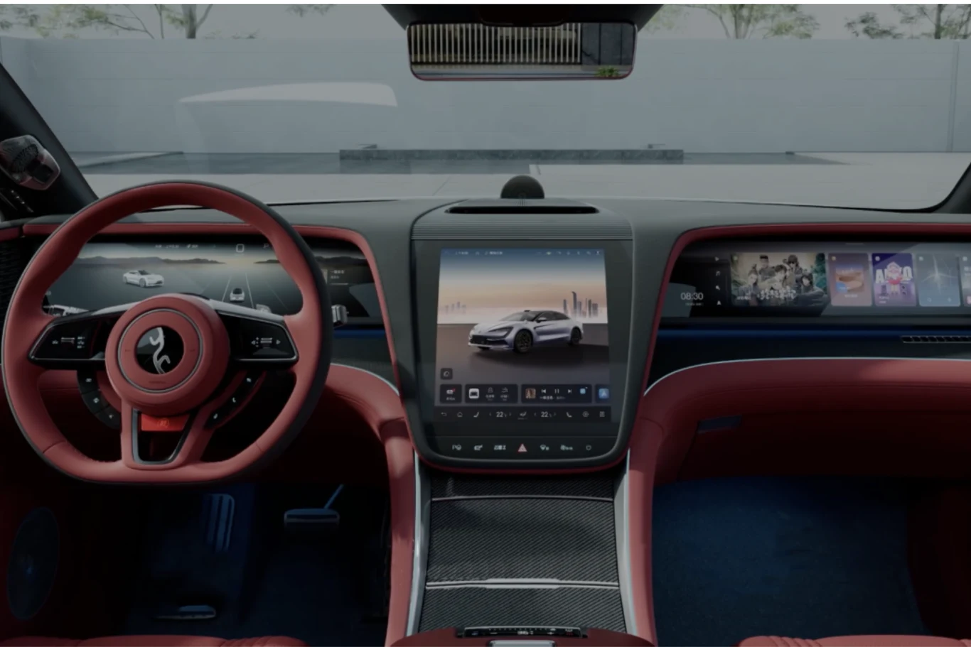 Nowoczesne wnętrze samochodu z dominującym wyświetlaczem na konsoli centralnej, cyfrowymi zegarami za kierownicą oraz szerokim panelem multimedialnym na desce rozdzielczej, wykończone czerwono-czarną tapicerką.