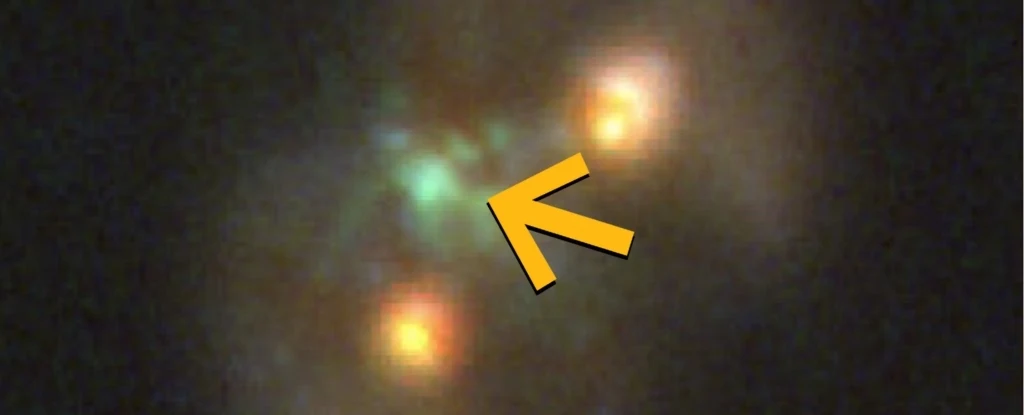 Zielone i pomarańczowe rozświetlone obiekty na czarnym tle, z dużą żółtą strzałką skierowaną na zielone światło pośrodku kadru.