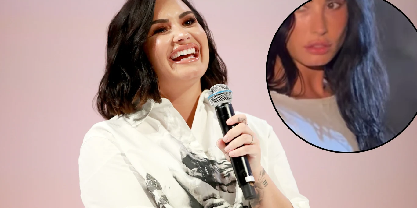 Demi Lovato Uśmiechnięta kobieta z krótkimi, ciemnymi włosami trzyma mikrofon w dłoni, ubrana w jasną bluzę z nadrukiem twarzy. W prawym górnym rogu umieszczone jest powiększone, okrągłe zdjęcie innej kobiety z długimi, ciemnymi włosami patrzącej poważnie w stronę...