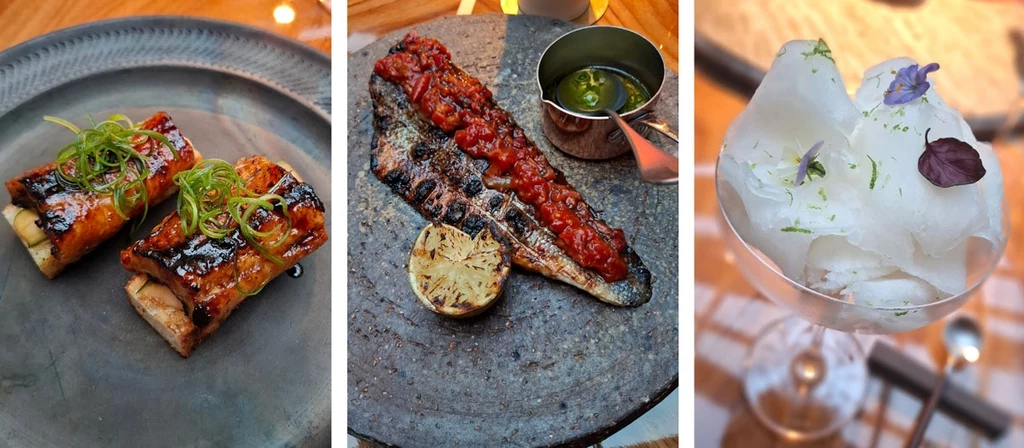 Dania łączą japońskie i europejskie wpływy Trzy elegancko podane dania kuchni restauracyjnej, po lewej grillowane roladki z nadzieniem i szczypiorkiem, w środku filet rybny z sosem pomidorowym i opiekaną cytryną, po prawej lekki deser z białą pianką i dekoracją z płatków kwiatów.