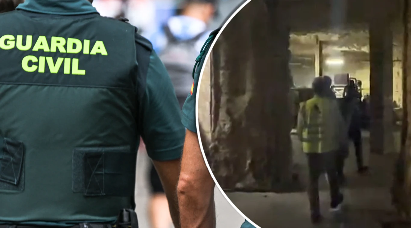 Zdjęcie nielegalnej fabryki tytoniu opublikowane przez hiszpańską Straż Cywilną Funkcjonariusz Guardia Civil w mundurze z widocznym napisem oraz kilku funkcjonariuszy w żółtych kamizelkach w środku budynku o surowej konstrukcji.