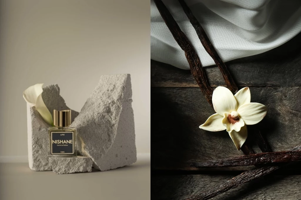 Butelka perfum Nishane ustawiona na jasnych fragmentach skały, obok waniliowy kwiat oraz laski wanilii na drewnianym tle. Wyeksponowane połączenie eleganckiego produktu i naturalnych składników.