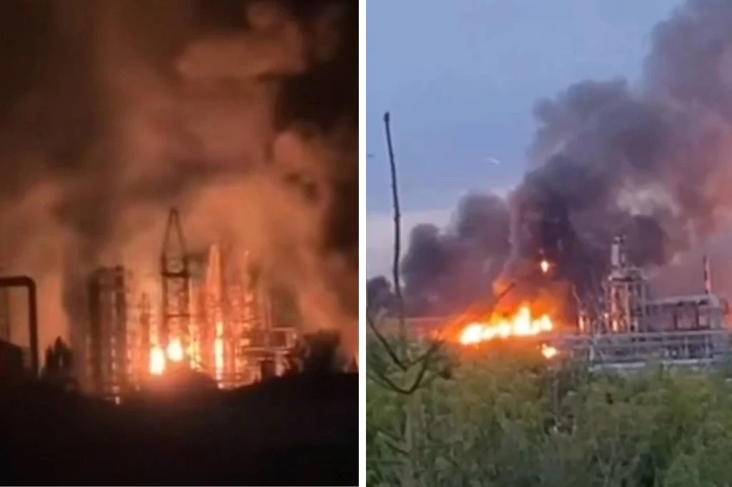 Drony zaatakowały dwie rafinerie w Rosji. Wybuchły pożary Wielki pożar w zakładzie przemysłowym z intensywnymi płomieniami i gęstym czarnym dymem unoszącym się nad konstrukcją, otoczony roślinnością i fragmentami infrastruktury.