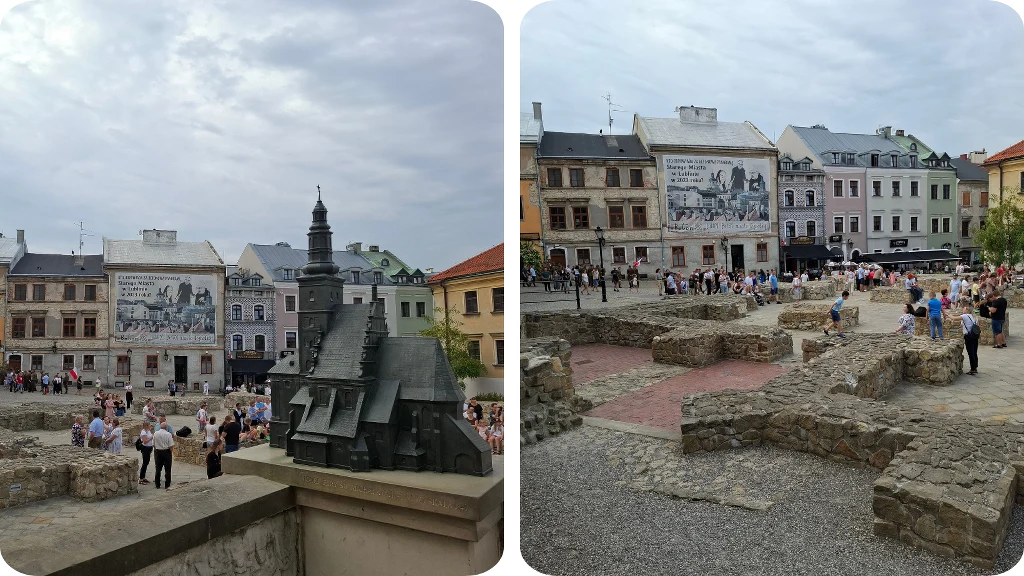 Tłum ludzi zgromadzony na placu z widocznymi ruinami kamiennych murów, otoczony kamienicami z historycznymi muralami, w tle makieta zabytkowego budynku.