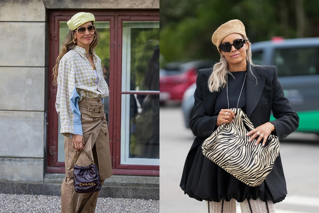 Dwie kobiety ubrane zgodnie z najnowszymi trendami mody, każda trzyma stylową torbę, obie mają okulary przeciwsłoneczne oraz oryginalne berety, tło stanowi miejska architektura i ulica.