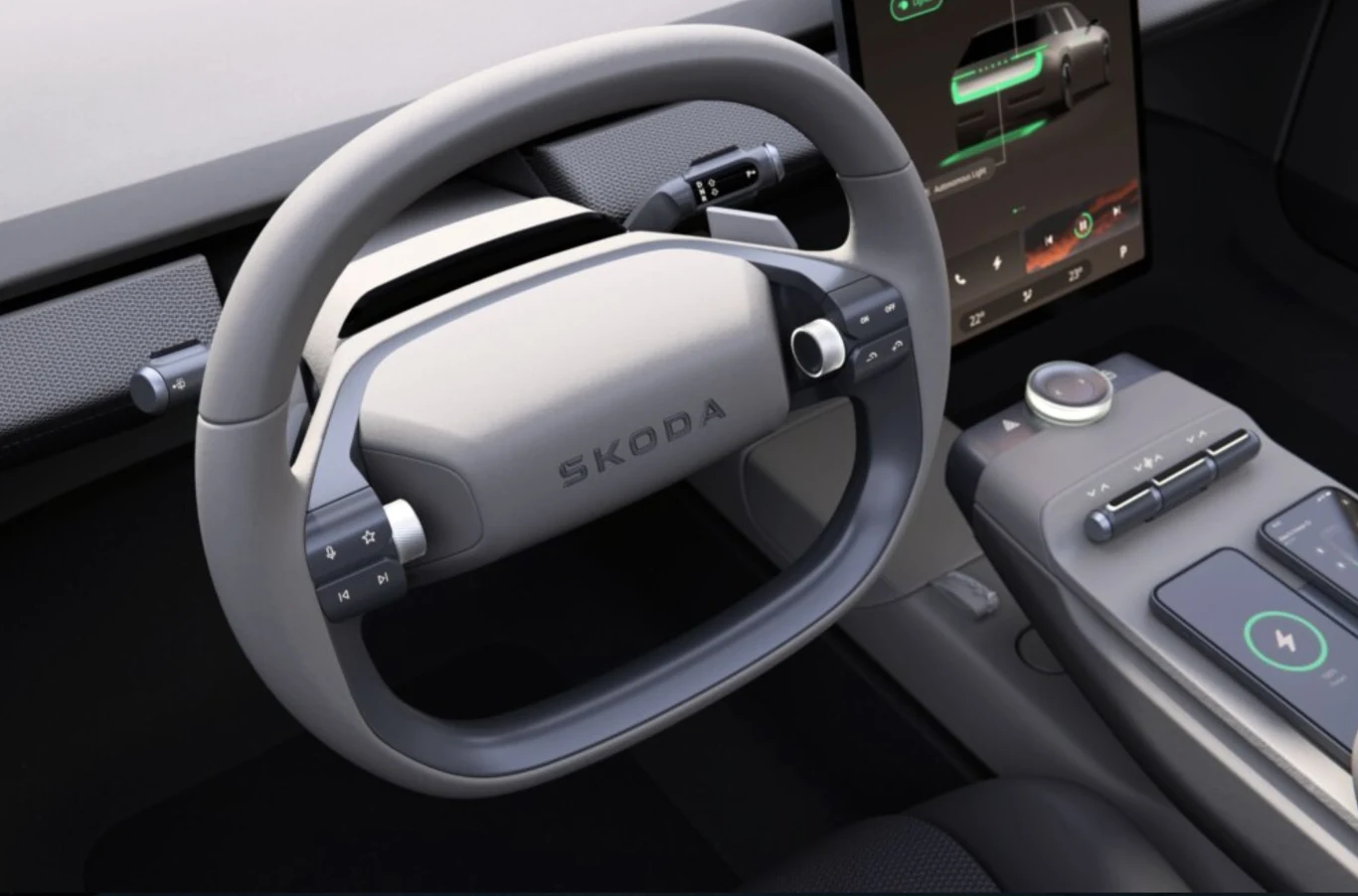 Kierownica samochodu marki Škoda o nowoczesnym wyglądzie, widoczny duży ekran dotykowy na konsoli środkowej, liczne przyciski i selektor zmiany biegów w nowoczesnym wnętrzu pojazdu.