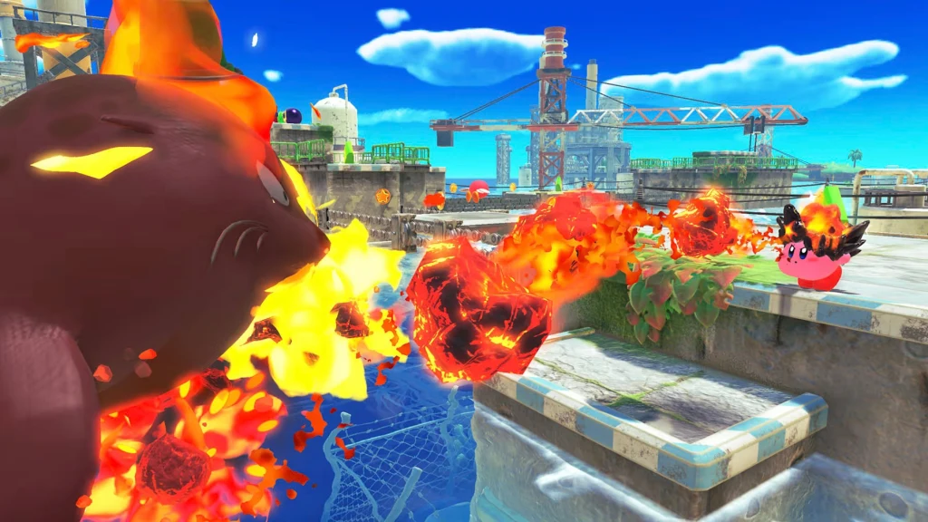 Kirby and the Forgotten Land - Nintendo Switch 2 Edition + Star-Crossed World Dwie kreskówkowe postacie walczą na tle placu budowy, jedna z nich zieje ogniem, a druga oddaje strzał z ognia, wokół widoczne są płomienie i kolorowe elementy otoczenia.