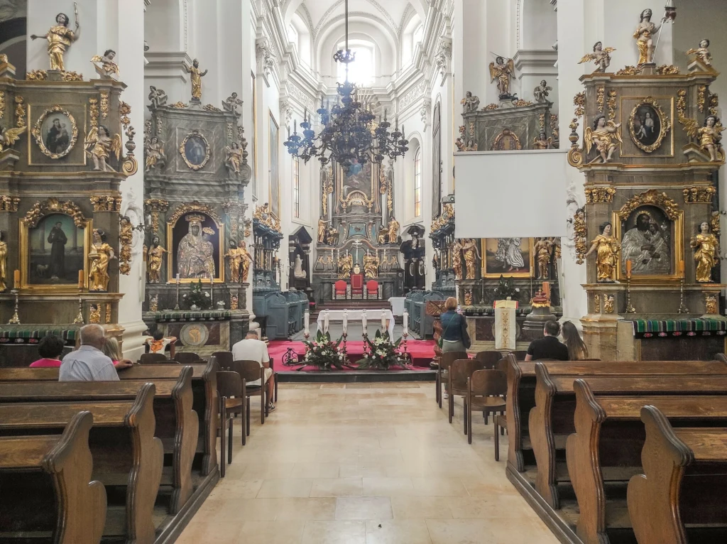 3 grudnia Kościół wspomina św. Franciszka Ksawerego Bogato zdobione wnętrze kościoła z drewnianymi ławkami, ołtarzem otoczonym złotymi elementami i licznymi obrazami oraz rzeźbami świętych, w ławkach siedzą osoby zatopione w modlitwie.