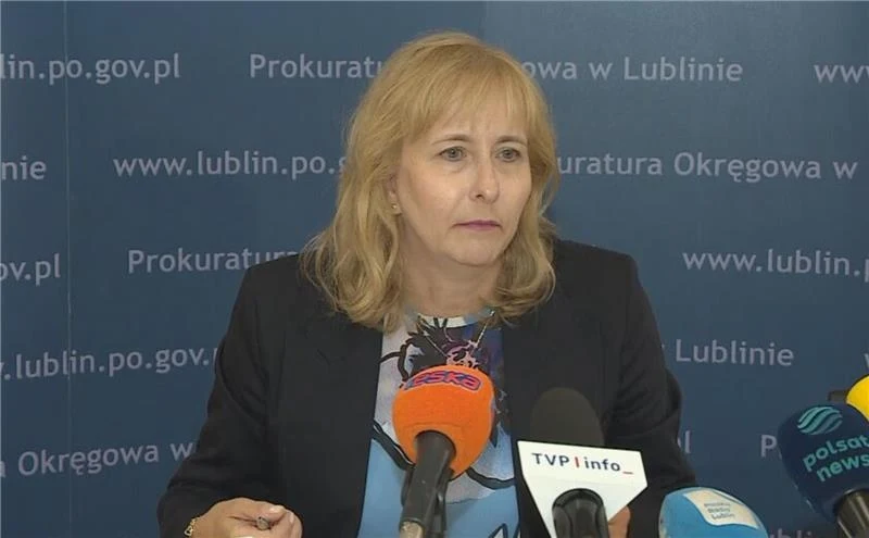 Prokuratura wszczęła postępowanie w sprawie dronów, które naruszyły polską przestrzeń powietrzną Kobieta z jasnymi włosami w średnim wieku, ubrana w granatową marynarkę, siedzi przy stole z mikrofonami kilku stacji telewizyjnych i prasowych; w tle niebieska ścianka z napisem Prokuratura Okręgowa w Lublinie.