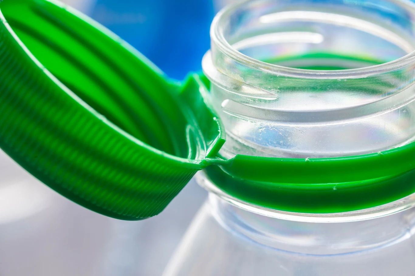 System kaucyjny rusza w Polsce od 1 października 2025 r Zbliżenie zielonej zakrętki plastikowej butelki oraz szyjki butelki z wyraźnymi detalami gwintu.