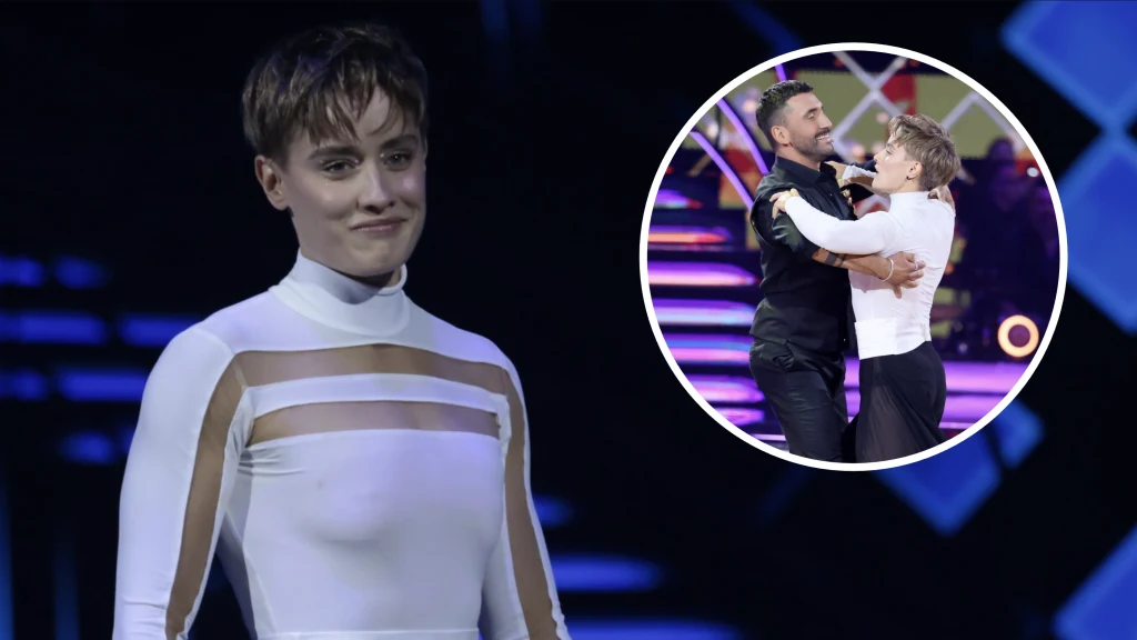 Uczestniczka ubrana w jasny kostium z przezroczystymi wstawkami stoi na scenie, w prawym górnym rogu dodatkowo pokazana jest para tańcząca podczas programu tanecznego, w jasnym oświetleniu i kolorowej scenerii.