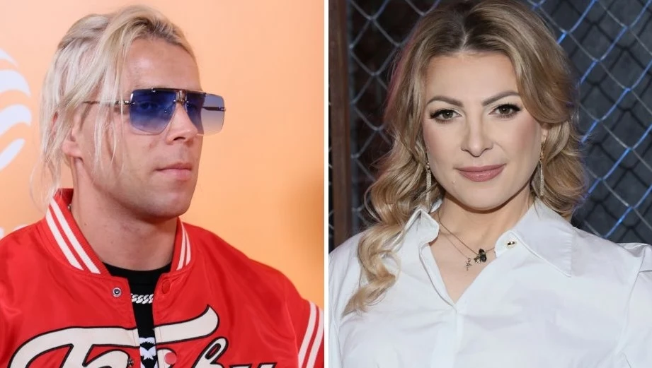 Skolim i Magda Narożna poznali się na planie Disco Star Po lewej stronie kadru mężczyzna w czerwonej kurtce z jasnymi włosami i okularami przeciwsłonecznymi na tle pomarańczowej ściany, po prawej stronie kobieta z falowanymi blond włosami, w białej koszuli, stoi przed siatką ogrodzeniową.