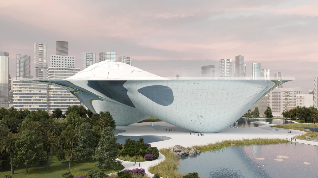 Futurystyczny budynek o nietypowej, organicznej bryle zawieszony nad ziemią, otoczony zielenią, wodą i wysokimi wieżowcami w tle, tworząc kontrast między naturą a nowoczesną architekturą miejską.