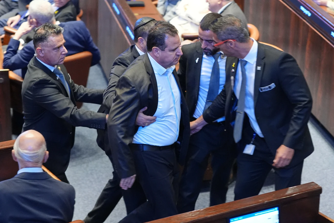 Incydent podczas przemówienia Donalda Trumpa w Knesecie. Mężczyzna wyprowadzony z sali Interwencja kilku ochroniarzy wobec mężczyzny w garniturze w trakcie oficjalnego zgromadzenia parlamentarnego, obecność wielu uczestników oraz napięta atmosfera.