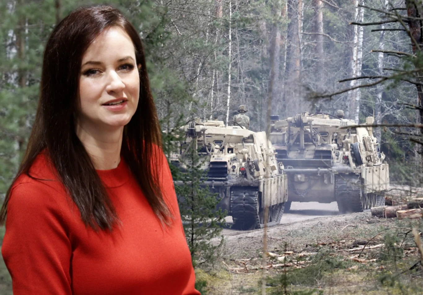 Premier Litwy Inga Ruginienė zapowiedziała rekordowe wydatki na obronność w 2026 roku Kobieta w czerwonym swetrze stoi na tle lasu, w którym widoczne są dwa wojskowe pojazdy pancerne poruszające się po leśnej drodze.