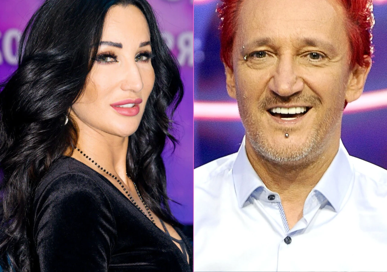 Justyna Steczkowska, Michał Wiśniewski Dwie osoby widoczne na podzielonym ekranie, kobieta z długimi czarnymi włosami w czarnej sukience oraz mężczyzna o czerwonych włosach i kolczyku pod dolną wargą, oboje uśmiechnięci na tle kolorowego światła.