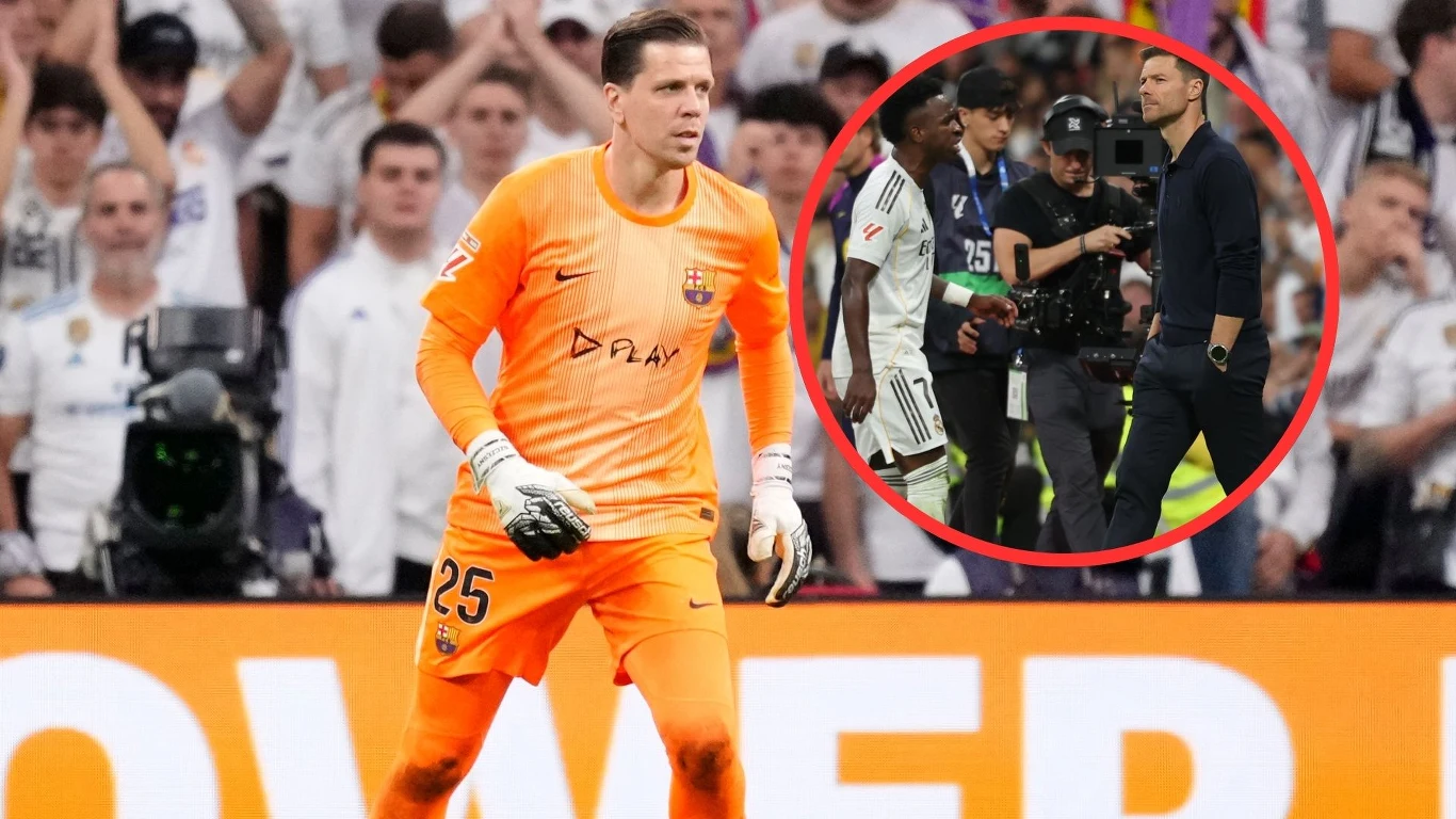 Wojciech Szczęsny, Vinicius Jr. oraz Xabi Alonso Bramkarz w pomarańczowym stroju piłkarskim znajduje się na boisku podczas meczu, na tle tłumu kibiców, w okręgu po prawej stronie widoczni są piłkarze, operator kamery oraz trener przy linii bocznej.