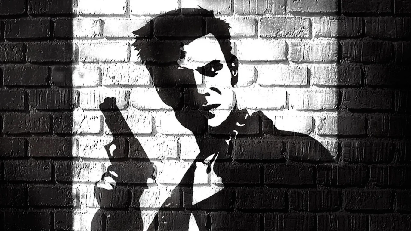 Max Payne Czarno-białe graffiti Max Payne'a z pistoletem na tle ceglanej ściany, kontrastowa stylistyka.