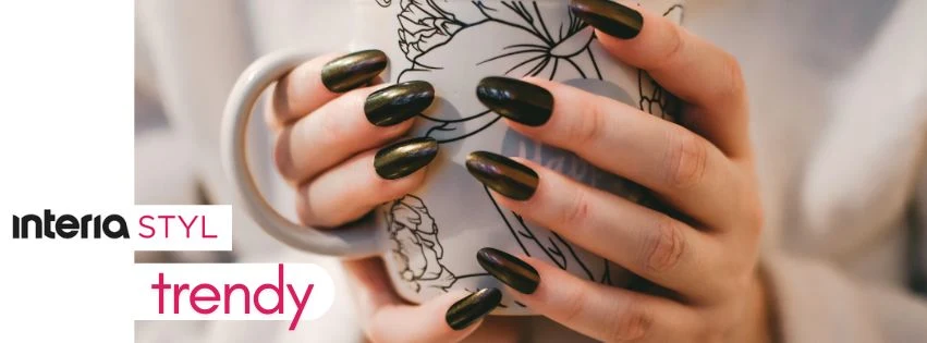 Dłonie z zadbanymi, ciemnymi paznokciami trzymają kubek z czarno-białym kwiatowym wzorem. Po lewej stronie logo interia STYL trendy.