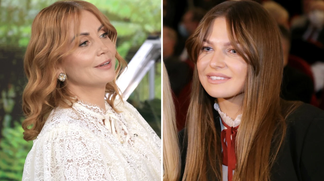 Katarzyna Zielińska, Anna Lewandowska Dwie kobiety z długimi włosami, jedna w białej koronkowej bluzce z perłowymi kolczykami, druga w ciemnej marynarce z jasnoczerwonym akcentem przy kołnierzyku, obie patrzące w stronę obiektywu w jasnym otoczeniu.