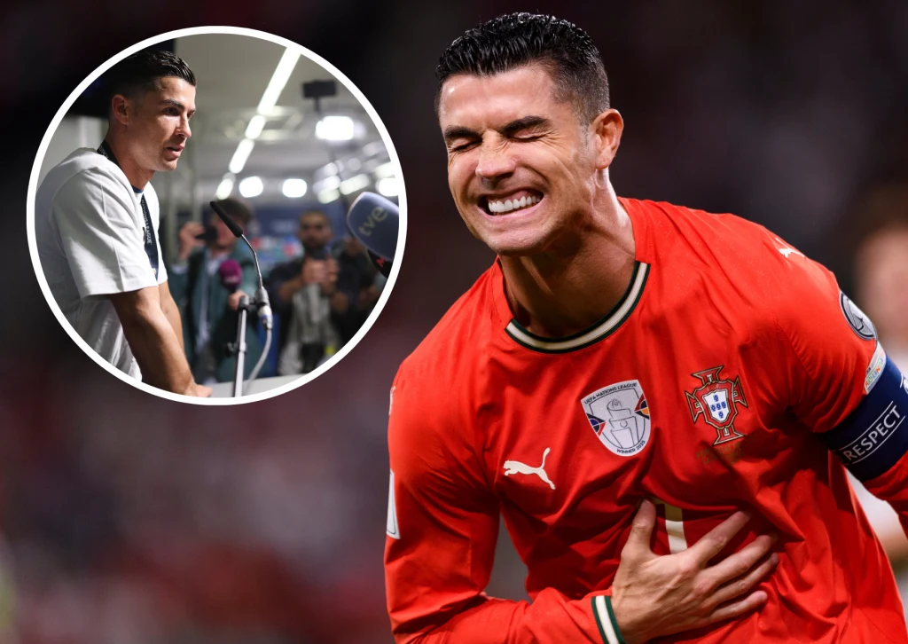 Piłkarz w czerwonym stroju reprezentacji Portugalii z opaską kapitańską na ramieniu wyraża silne emocje, trzymając się za brzuch z zaciśniętymi zębami. W prawym górnym rogu znajduje się okrągłe wstawienie prezentujące tę samą osobę udzielającą wywiadu ...