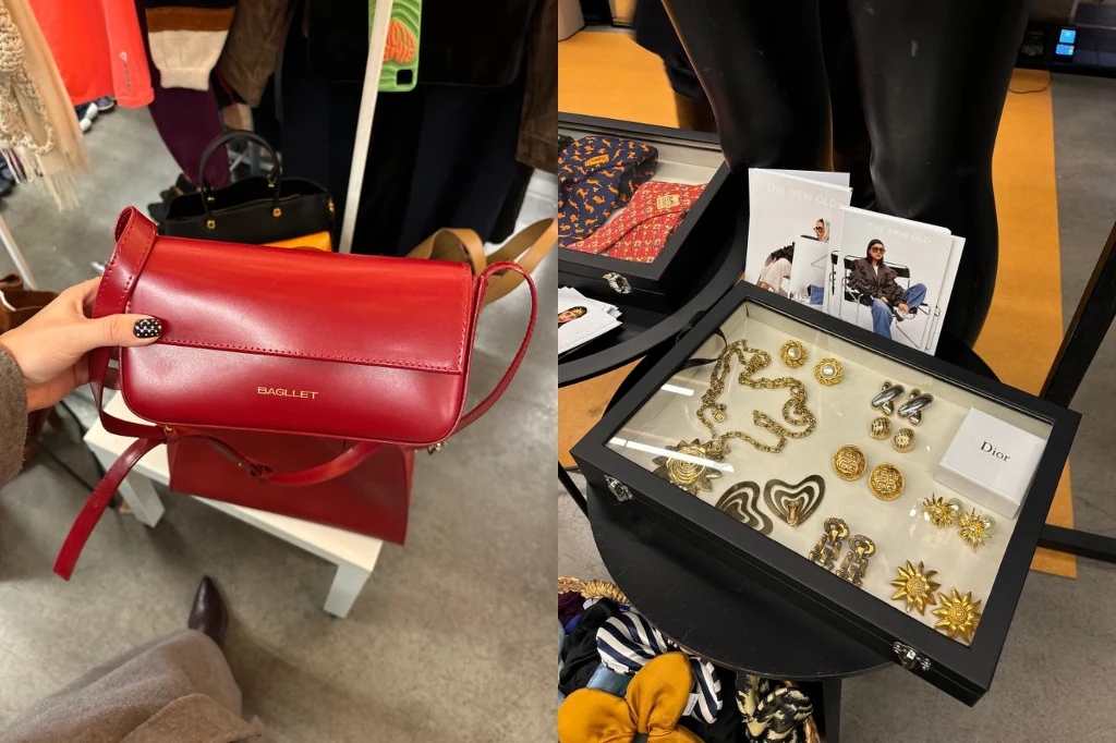 Czerwona torebka na pasku marki Shoulder prezentowana w sklepie oraz ekspozytor z biżuterią i dodatkami, w tym kolczyki, broszki i ozdoby sygnowane marką Dior, wyeksponowane na czarnym stoliku obok kolorowych apaszek.